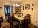 Cozy dining room with wood table set and hutch, perfect for Gathering meals at 27 Cedar Tree Ter, Ocala, FL 34472
