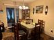 Cozy dining room with wood table set and hutch, perfect for Gathering meals at 27 Cedar Tree Ter, Ocala, FL 34472