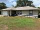 Charming single-story home featuring a well-maintained lawn and an attached garage at 27 Cedar Tree Ter, Ocala, FL 34472