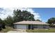 Charming single-story home featuring an attached two-car garage and landscaped front yard at 27 Cedar Tree Ter, Ocala, FL 34472