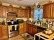 Kitchen featuring stainless steel appliances, wooden cabinets, and granite countertops at 27 Cedar Tree Ter, Ocala, FL 34472