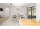 Elegant dining area with chandelier, table, and sliding glass doors at 2701 Ne 10Th St # 101, Ocala, FL 34470