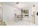 Inviting dining room with tile floors, chandelier, and sliding glass doors to screened patio at 2701 Ne 10Th St # 101, Ocala, FL 34470