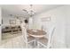 Dining area featuring tiled floors, wooden table and chairs with modern chandelier at 2701 Ne 10Th St # 101, Ocala, FL 34470