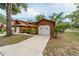 Charming exterior view of home, featuring garages and manicured landscaping at 2701 Ne 10Th St # 101, Ocala, FL 34470