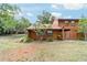 Charming townhouse featuring wood siding, mature trees, and lush landscaping at 2701 Ne 10Th St # 101, Ocala, FL 34470