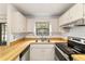 Bright kitchen with stainless steel appliances, white cabinets and wood countertops at 2701 Ne 10Th St # 101, Ocala, FL 34470