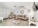 Bright living room featuring neutral decor, plush sofas, and a stylish ceiling fan at 2701 Ne 10Th St # 101, Ocala, FL 34470
