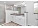 Bathroom with a double vanity, granite countertop, and a glass-enclosed walk-in shower at 3270 Sw 151St Ct, Ocala, FL 34481