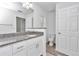 Bathroom featuring a single vanity with granite countertop and a separate toilet room at 3270 Sw 151St Ct, Ocala, FL 34481