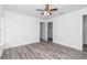 Empty bedroom with a fan and two closets, and a gray wood-look floor at 3270 Sw 151St Ct, Ocala, FL 34481