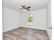 Bright bedroom features wood-look flooring, a ceiling fan and a window for natural light at 3270 Sw 151St Ct, Ocala, FL 34481