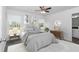 Stylishly furnished bedroom with a ceiling fan, two windows, and a curated decor at 3270 Sw 151St Ct, Ocala, FL 34481