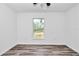 This bedroom has wood-look flooring and a window offering ample natural light at 3270 Sw 151St Ct, Ocala, FL 34481