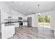 Bright kitchen boasts stainless steel appliances, white cabinets, a granite countertop, and wood flooring at 3270 Sw 151St Ct, Ocala, FL 34481