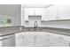 Modern kitchen with granite countertops, stainless steel appliances, and white cabinetry at 3270 Sw 151St Ct, Ocala, FL 34481