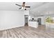 Light-filled living area with neutral walls and hardwood flooring, flowing into an open kitchen concept at 3270 Sw 151St Ct, Ocala, FL 34481