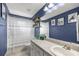Stylish bathroom featuring white fixtures, gray countertop, and classic blue walls at 380 Ne 53Rd St, Ocala, FL 34479