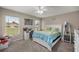 Well-lit bedroom with neutral walls, a ceiling fan, and a cozy carpet at 380 Ne 53Rd St, Ocala, FL 34479