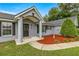 Inviting front entrance with fresh mulch, mature landscaping, and a covered porch at 380 Ne 53Rd St, Ocala, FL 34479