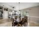 Bright eat-in kitchen featuring white cabinets, stainless steel appliances, granite countertops, island and an adjacent dining area at 380 Ne 53Rd St, Ocala, FL 34479