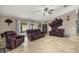 Open-concept living room boasts tile flooring, ceiling fan, and leather furniture set at 380 Ne 53Rd St, Ocala, FL 34479