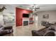 Cozy living room features a fireplace with a red accent wall, tile flooring, and casual seating at 380 Ne 53Rd St, Ocala, FL 34479