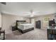 Spacious main bedroom featuring dark wood furniture, ceiling fan, neutral carpet, and ample natural light at 380 Ne 53Rd St, Ocala, FL 34479