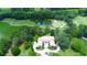Stunning aerial view of the estate home surrounded by a lush golf course, a serene pond and a circular driveway at 4026 Nw 85Th Ter, Ocala, FL 34482