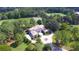 Stunning aerial view of property surrounded by lush greenery, landscaping, and golf course at 4026 Nw 85Th Ter, Ocala, FL 34482
