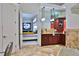 Spa-like bathroom with marble floors, cabinetry, mirrors, and a glimpse into the luxurious main bedroom at 4026 Nw 85Th Ter, Ocala, FL 34482