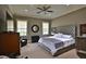 Spacious bedroom with a tufted headboard, neutral color scheme, and ample natural light at 4026 Nw 85Th Ter, Ocala, FL 34482