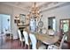 Formal dining room with a chandelier, fireplace, and elegant table setting at 4026 Nw 85Th Ter, Ocala, FL 34482