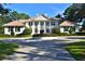Stately home with manicured front lawn, circular driveway, and elegant architectural details at 4026 Nw 85Th Ter, Ocala, FL 34482