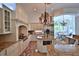 Bright kitchen featuring custom cabinets, granite countertops, stainless steel appliances, and an adjacent breakfast area at 4026 Nw 85Th Ter, Ocala, FL 34482
