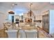 Well-lit kitchen with granite countertops, stainless steel appliances, kitchen island with seating, and decorative backsplash at 4026 Nw 85Th Ter, Ocala, FL 34482