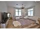 Expansive living room with tile floors, a white sectional sofa, large windows, and decorative area rugs at 4026 Nw 85Th Ter, Ocala, FL 34482