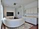 Bright living room featuring a large curved sofa, built-in bar, and entertainment center at 4026 Nw 85Th Ter, Ocala, FL 34482