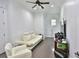 Cozy seating area with modern sofa and chair, featuring wood floors and ample space at 4026 Nw 85Th Ter, Ocala, FL 34482