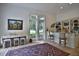 Bright living room featuring bar seating and large windows overlooking the landscaped backyard at 4026 Nw 85Th Ter, Ocala, FL 34482