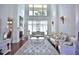 Elegant living room featuring soaring ceilings, grand windows, and ornate furnishings at 4026 Nw 85Th Ter, Ocala, FL 34482