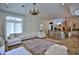 Open-concept living area with tile floors, a large sectional sofa, and a modern kitchen island at 4026 Nw 85Th Ter, Ocala, FL 34482
