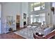 Elegant living room featuring soaring ceilings, grand windows, and ornate furnishings at 4026 Nw 85Th Ter, Ocala, FL 34482