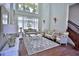 Elegant living room featuring soaring ceilings, grand windows, and ornate furnishings at 4026 Nw 85Th Ter, Ocala, FL 34482