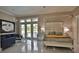 Bright main bedroom features a lavish bed, chandelier, sitting area, and access to an outdoor space at 4026 Nw 85Th Ter, Ocala, FL 34482