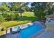 Aerial view of a gorgeous pool and spa overlooking lush golf course scenery at 4026 Nw 85Th Ter, Ocala, FL 34482