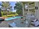 Inviting pool and patio area with golf course view, complete with elegant outdoor seating and stylish lanterns at 4026 Nw 85Th Ter, Ocala, FL 34482
