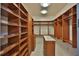 Spacious walk-in closet with custom shelving, drawers, and ample storage space for organization at 4026 Nw 85Th Ter, Ocala, FL 34482