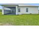 Spacious backyard featuring a covered patio with a stylish stone floor, ideal for outdoor entertaining at 4370 County Road 121D, Wildwood, FL 34785