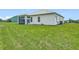 Expansive backyard with lush green grass and a covered patio, perfect for enjoying the outdoors at 4370 County Road 121D, Wildwood, FL 34785